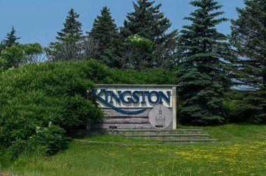 Kingston, ON, Canada - September 18, 2025: A welcome sign for the city of Kingston is visible from a highway on a cloudy day.