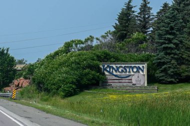 Kingston, ON, Canada - September 18, 2025: A welcome sign for the city of Kingston is visible from a highway on a cloudy day.