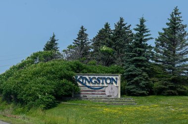 Kingston, ON, Canada - September 18, 2025: A welcome sign for the city of Kingston is visible from a highway on a cloudy day.