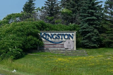Kingston, ON, Canada - September 18, 2025: A welcome sign for the city of Kingston is visible from a highway on a cloudy day.