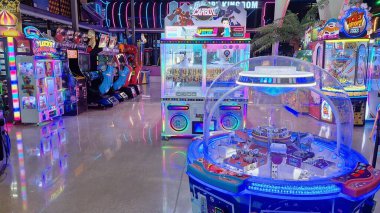 Toronto, ON, Kanada - 3 Şubat 2026: Geniş bir aile macera parkı Mutlu Krallık içindeki çeşitli atari makinelerini ve eğlence merkezlerini aydınlatan renkli neon ışıklar.