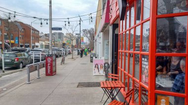 Toronto, ON, Kanada - 14 Nisan 2025: İnsanlar Durie Caddesi yakınlarındaki Bloor Caddesi boyunca 9 bahar öğleden sonra bulutlu bir gökyüzü altında yürüyüp alışveriş yapıyorlar.