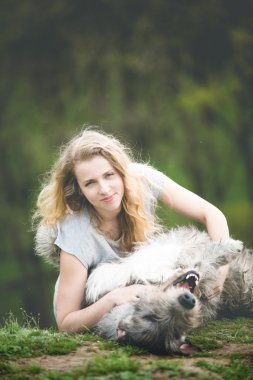 uzun hafif saçlı kız sarılmak büyük bir gri köpek