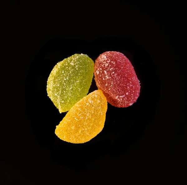 Colored jelly sweets on a black background — Stock Photo, Image