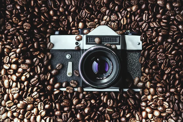 Foto câmera em grãos de café — Fotografia de Stock