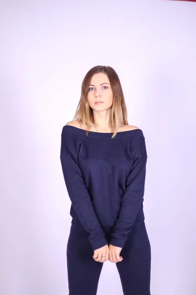 Young thin girl in a knitted suit on a light background. Tenderness, femininity. — Stock Photo, Image