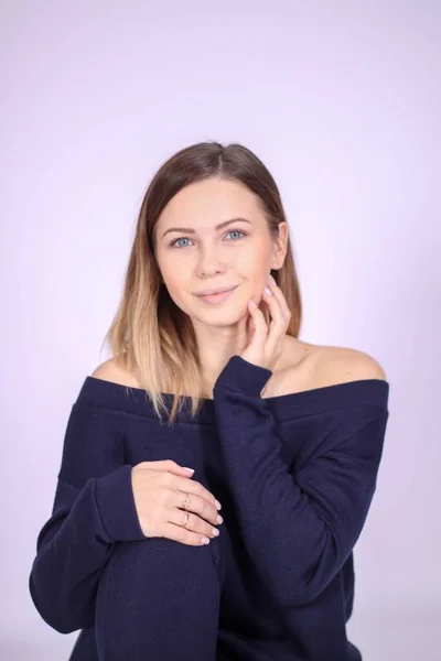 Young thin girl in a knitted suit on a light background. Tenderness, femininity. — Stock Photo, Image