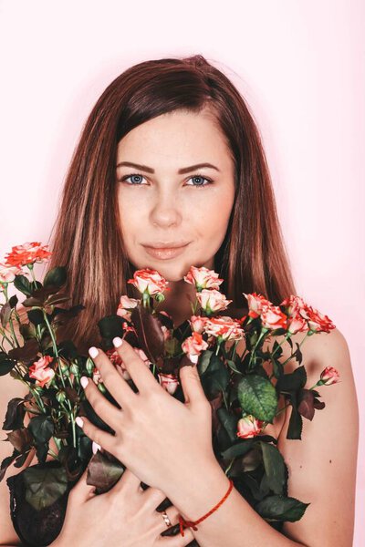 sweet, tender. sexy woman with roses on a light background