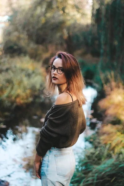 Sessão de fotos de outono de uma menina bonita com cabelo escuro na floresta. — Fotografia de Stock