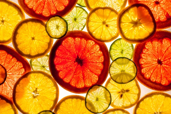 Sliced citrus fruits background — Stock Photo, Image