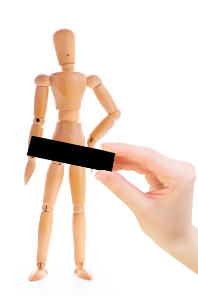 Wooden man with a hand holding a black rectangle. — Stock Photo, Image