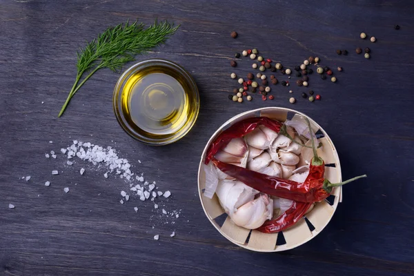 Food ingredients: spices, herbs, garlic, pepper mix, chili pepper, olive oil, dill, salt. Top view on rustic wooden table. — Stock Photo, Image
