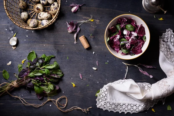 Taze bahar salatası fesleğen, yumurta, radicchio yaprakları ve koyu ahşap masa, üstten görünüm sarımsak. 
