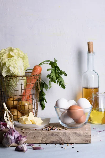 Closeup of fresh vegetables, eggs and butter on kitchen counter. Healthy nutrition background. — Stock Photo, Image