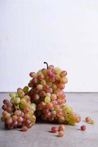 Ripe grapes, white and rose wine grape, light background, copy space.