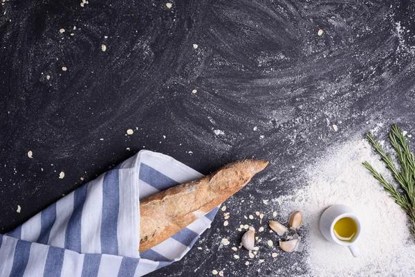 Freshly baked french baguette on rustic background with copy space, close up. Top view. — Stok fotoğraf