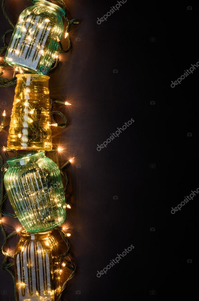 Xmas Lights In Glass Vase Over Dark Background Christmas Card