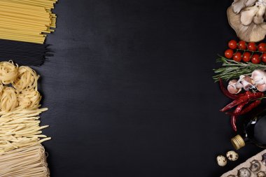 Yumurta, mantar ve İtalyan mutfağı malzemeler siyah ahşap zemin üzerine çeşitli makarna. Üstten Görünüm, kopya alanı.