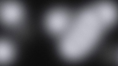 Karanlık arkaplanda bulanık beyaz ışık şekilleri yumuşak soyut atmosfer yaratır