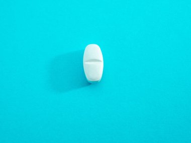 White pill on a blue background, isolate, with place for text.