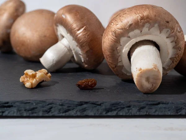 Champignons on Table. Mushrooms isolated on black background. — Stock Photo, Image