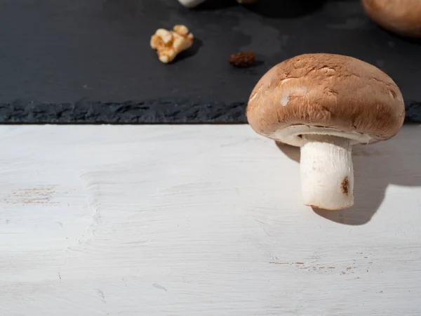 Champignons on Table. Mushrooms isolated on black background. — Stock Photo, Image