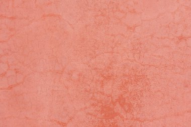 Terracotta Wall Texture. Close-up of a terracotta wall with natural cracks and subtle color variations. Warm tones create an earthy and rustic surface texture.