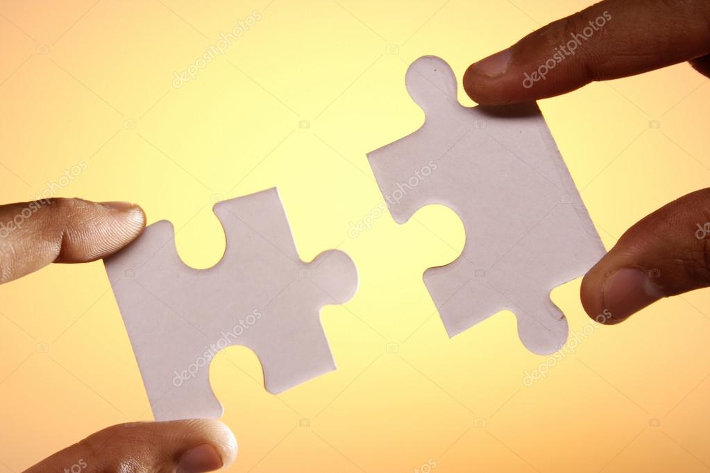 hands connecting two jigsaw puzzle pieces stock photo infocuss