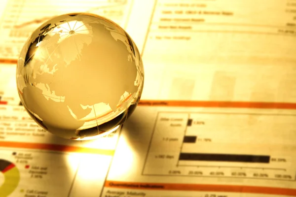 Glass globe on business document