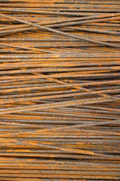 Vertical MCU of thin semi-rusty steel bars stacked in a horizontal position with some diagonal — Stock Photo, Image