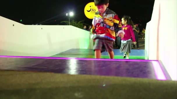 BANGKOK, THAILAND - April 27, 2015: Wide shot multiple people run up and down illuminated glowing stairs in slo-mo — Stock Video