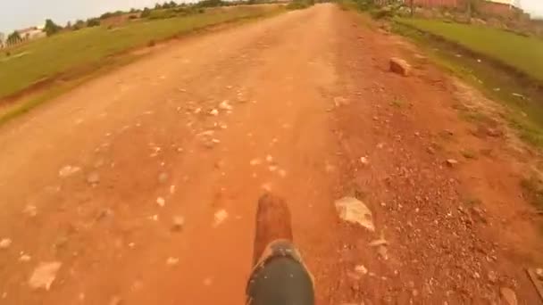 SIEM REAP, CAMBODIA - CIRCA JULY 2016: POV action cam view of hybrid mountain-road bike on rural Asian dirt road — Stock Video