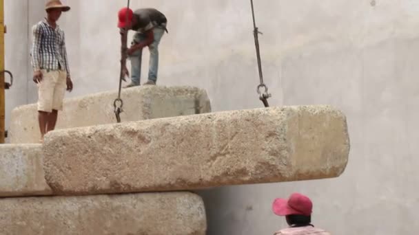 SIEAM REAP, CAMBODIA - CIRCA JULY 2015: Crane Lifts and Stacks Massive Blocks - Crane Visible — Stock Video