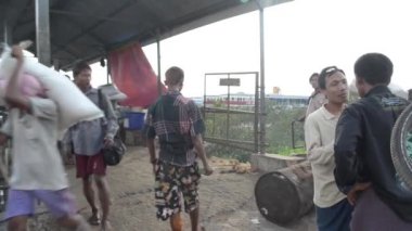 26 Nisan 2014 - Rangoon, Burma: Birçok hamallar taşımak kargo ve işçi rulo petrol davul