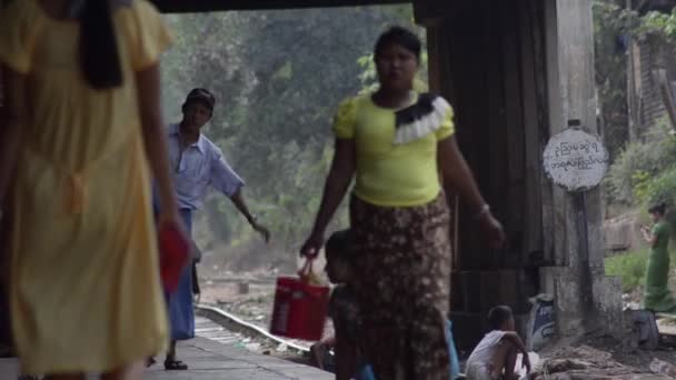 TRAIN LOCOMOTIVE: Telephoto view of people walking on train platform — Stock Video