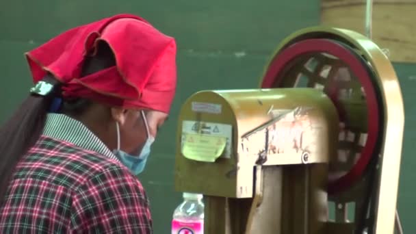 PHNOM PENH, CAMBODIA - SEPTEMBER 12, 2012: Asian Garment Industry Factory: Woman with Scarf at Machine — Stock Video