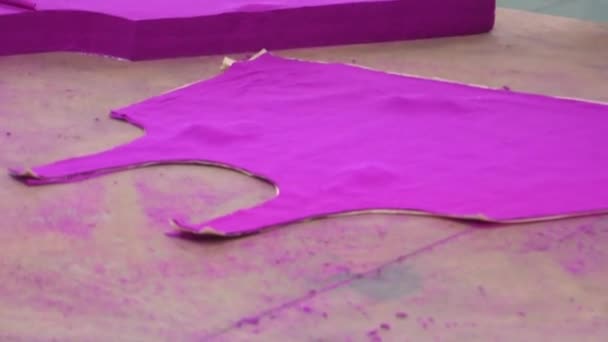 PHNOM PENH, CAMBODIA-SEPTEMBER 13, 2012: Textile Cloment Factory Workers: CU worker preps purple garment pieces — стоковое видео
