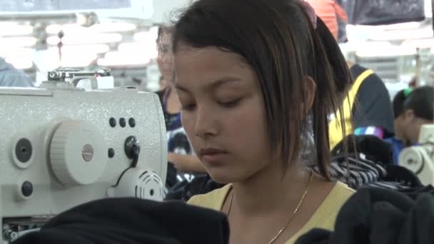 Tekstiltekstilfabrikk: Nærme kvinnelige arbeidere ved symaskin – stockvideo