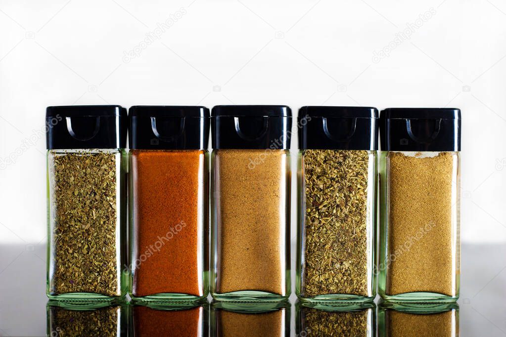 Bright variety of spices in glass jar - international world cuisine