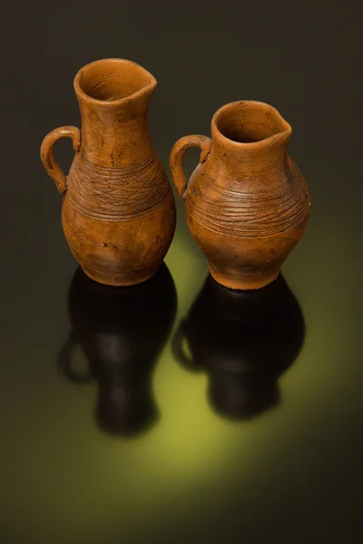 Beautiful decorative clay pots brown on a black background — Stock Photo, Image