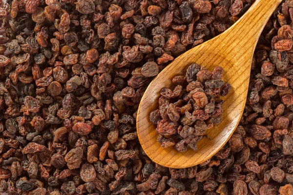 Macro background with a pile of raisins and wooden spoon Stock Photo