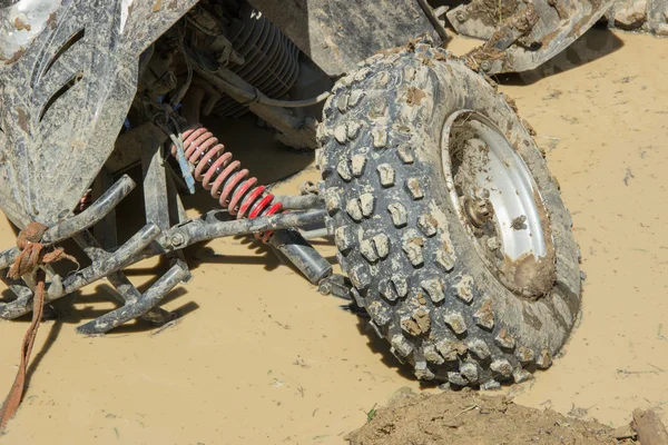 Grande ATV sujo preso em uma poça em uma estrada da floresta — Fotografia de Stock