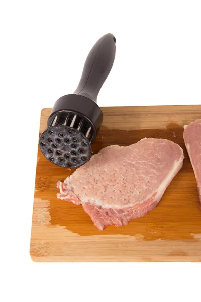 Beat the meat on a wooden board on a white background — Stock Photo, Image