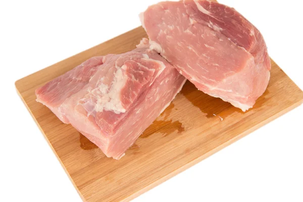 Raw piece of meat on a wooden board on a white background — Stock Photo, Image