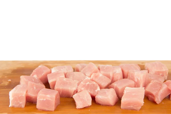 Pezzo di carne crudo su una tavola di legno su sfondo bianco — Foto Stock