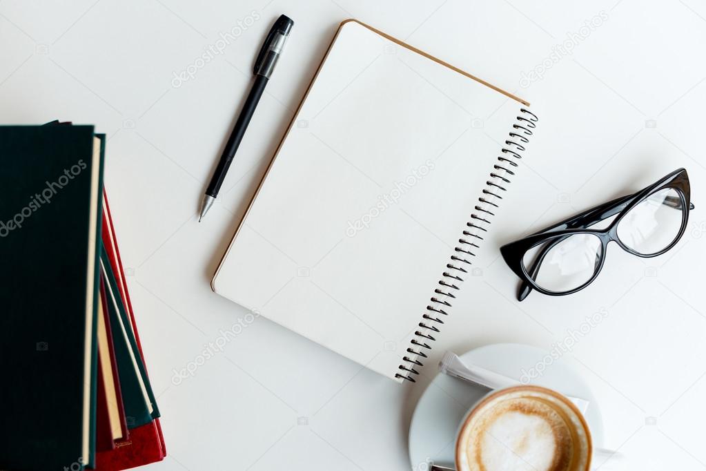 Clear notebook and  cup of coffee