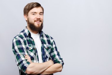 Young man with beard posing on white background
