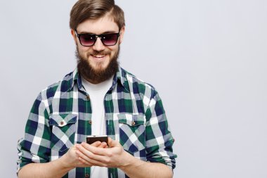 Sakallı mutlu adam akıllı telefon tutuyor