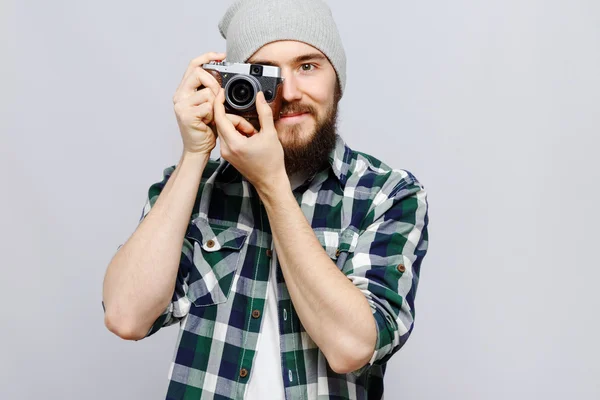 Smiling hipster holding camera — Stock Photo, Image