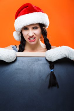 Angry young girl posing with blackboard